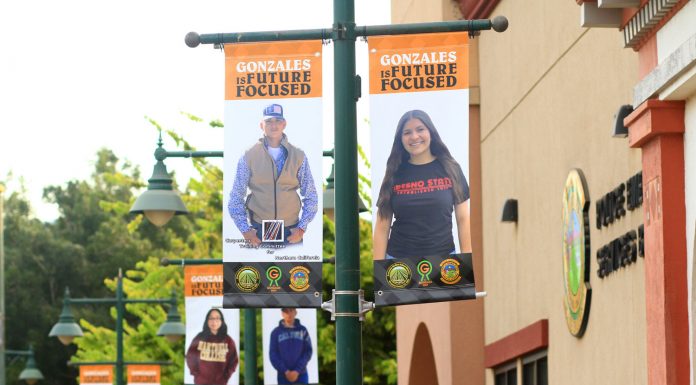 Gonzales hangs banners to honor recent graduates