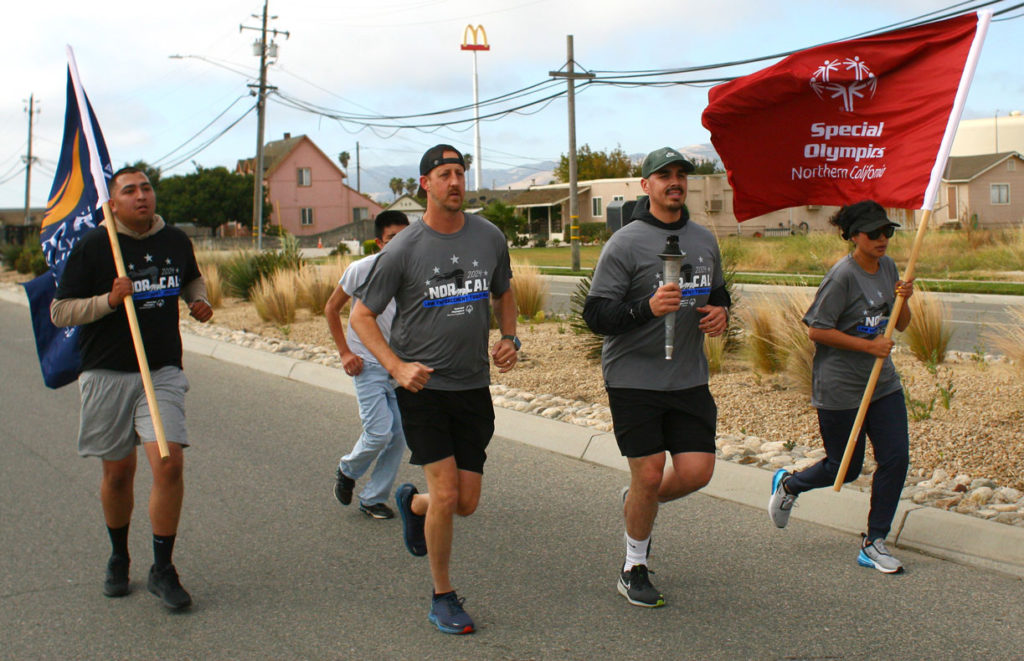 Image for display with article titled Officers Unite to Carry Flame of Hope Through Salinas Valley