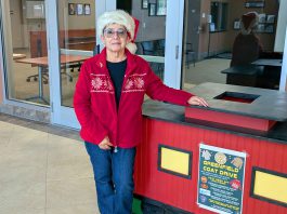 9th annual Greenfield Coat Drive gets underway Avelina Torres stands by coat donation bin