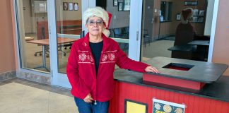 9th annual Greenfield Coat Drive gets underway Avelina Torres stands by coat donation bin