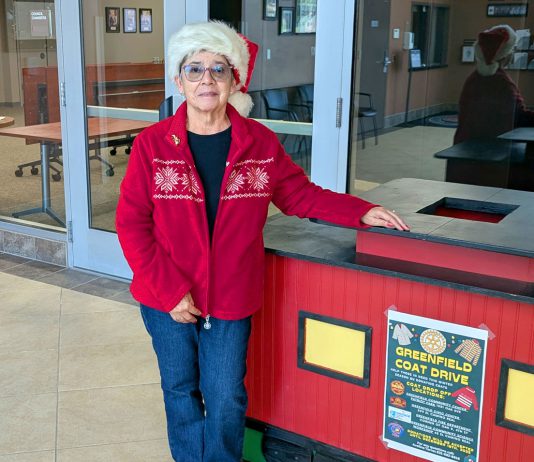9th annual Greenfield Coat Drive gets underway Avelina Torres stands by coat donation bin