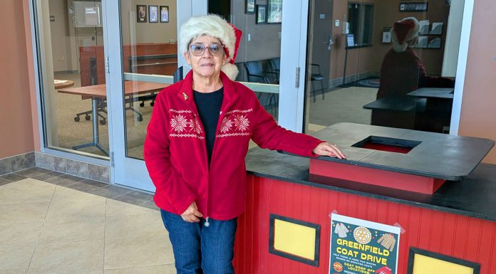 9th annual Greenfield Coat Drive gets underway Avelina Torres stands by coat donation bin