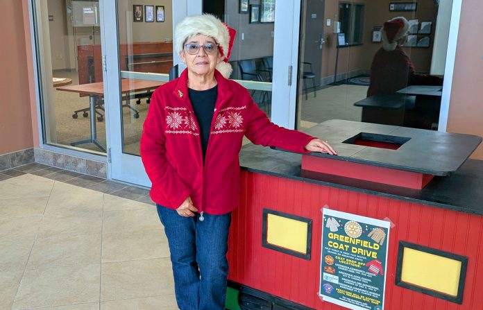 GF-coat-drive-2025-photo Avelina Torres stands by coat donation bin