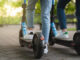 Mother and daughter riding electric scooters