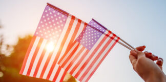 Salinas Valley cities prepare for 4th of July celebrations Woman holding USA flag celebrating Independence Day