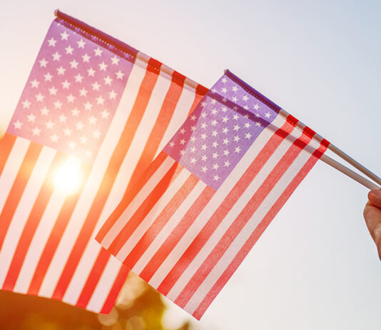 Salinas Valley cities prepare for 4th of July celebrations Woman holding USA flag celebrating Independence Day
