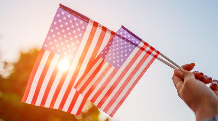 Salinas Valley cities prepare for 4th of July celebrations Woman holding USA flag celebrating Independence Day