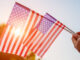 Woman holding USA flag celebrating Independence Day