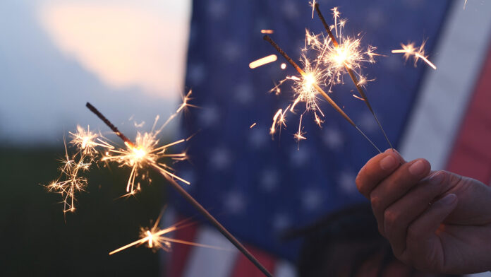 Hand holding sparkler fireworks
