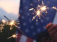 Hand holding sparkler fireworks