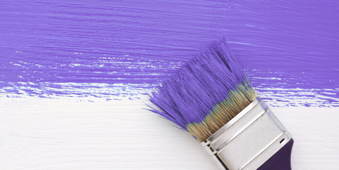 Purple paint brush AdobeStock_96605024 Stripe of purple paint with a paintbrush on white