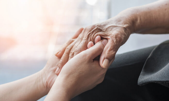 Senior hands alzheimer AdobeStock_336575544 Parkinson disease patient, Alzheimer elderly senior, Arthritis person hand in support of nursing family caregiver care for disability awareness day