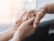 Parkinson disease patient, Alzheimer elderly senior, Arthritis person hand in support of nursing family caregiver care for disability awareness day