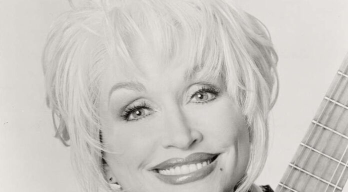 Give Like Dolly Day to support children’s literacy on Sept. 25 Dolly Parton with guitar