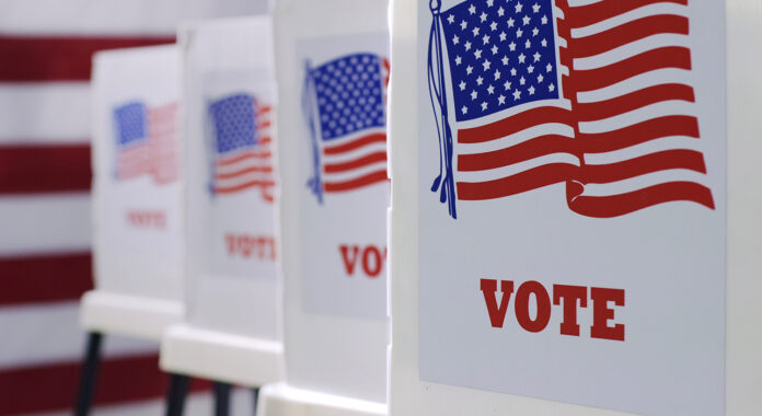 Vote_ballot_election_AdobeStock_352973247 voting booths at polling station during American election